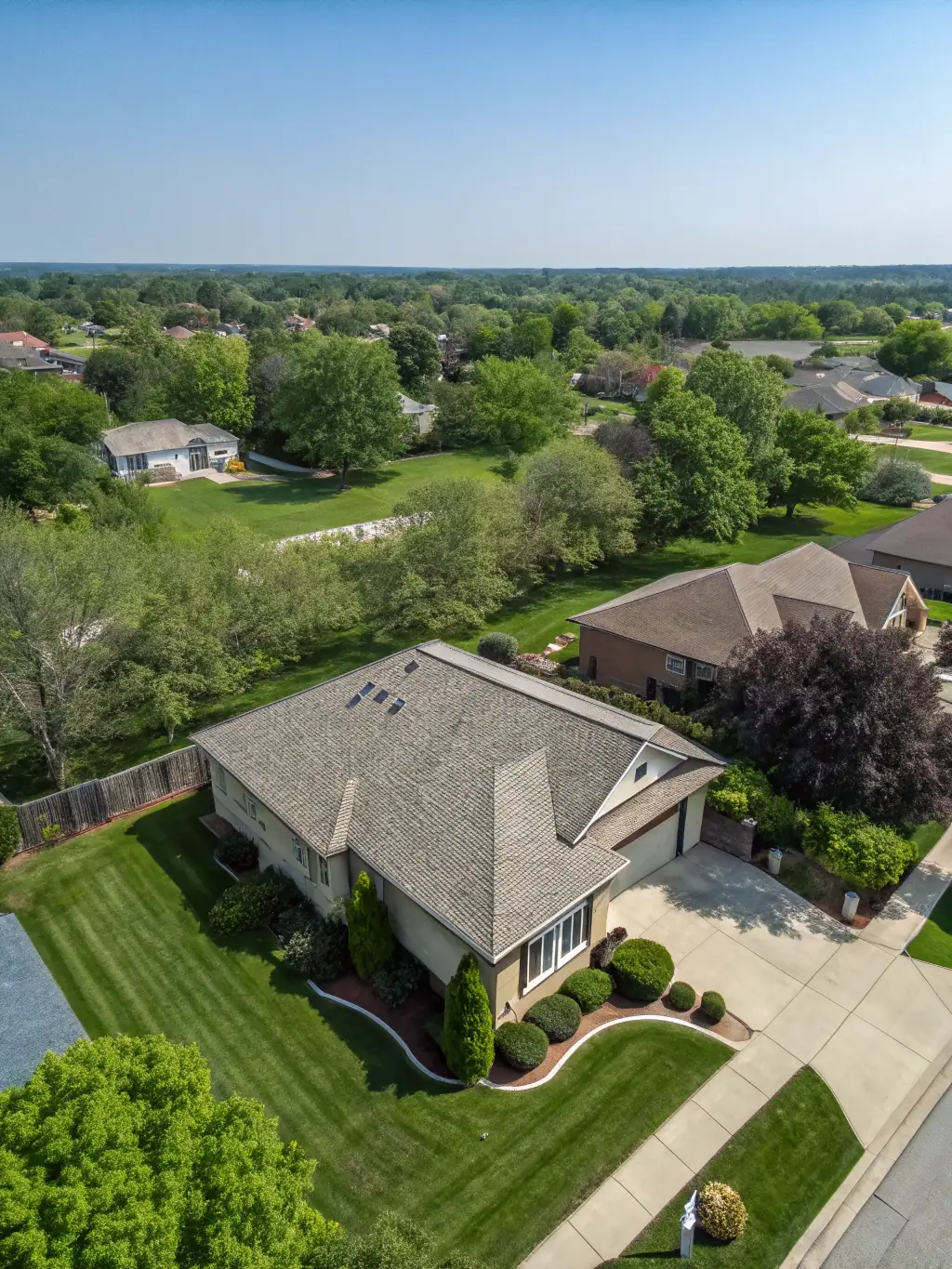Aerial shot of a residential property with a large backyard, capturing the home’s surroundings and neighborhood context, used to demonstrate the unique perspective offered by drone services.